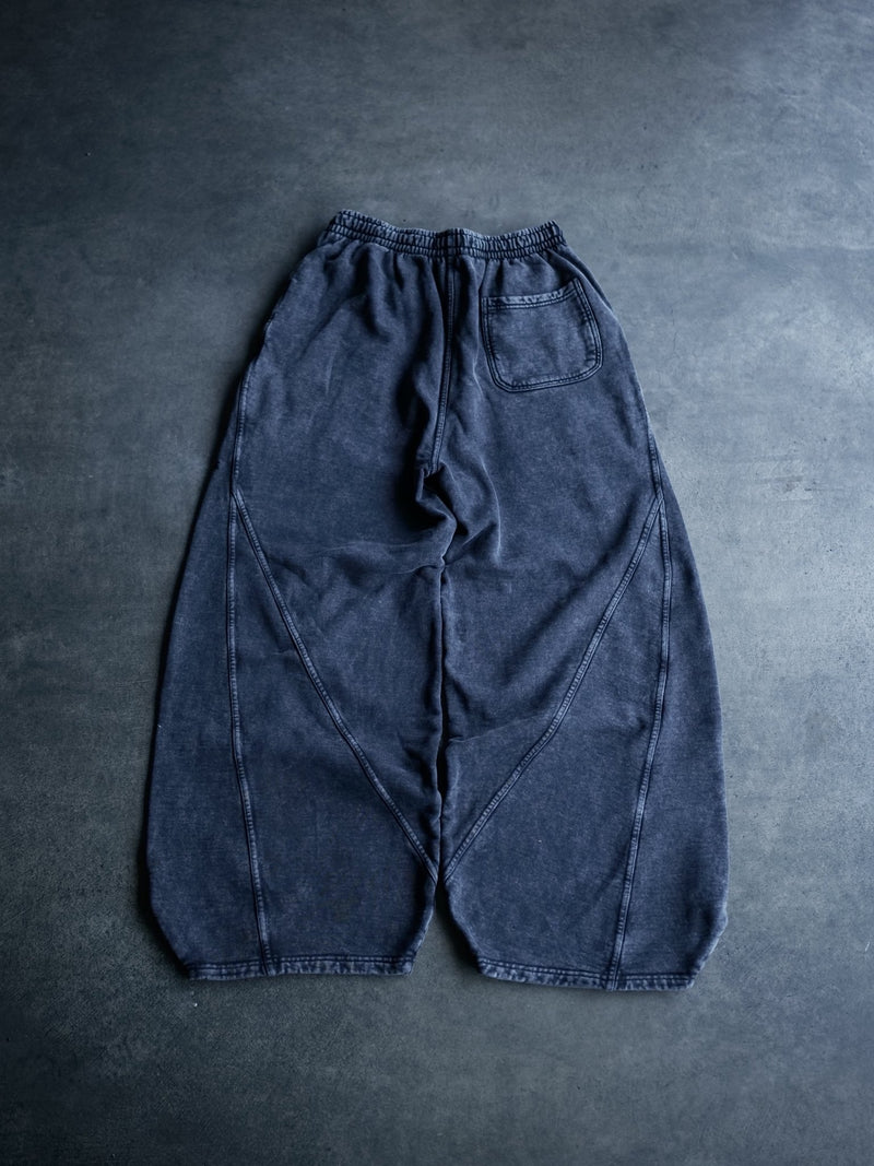 Goji Longevity black acid-washed baggy sweatpants — back view with seam detailing