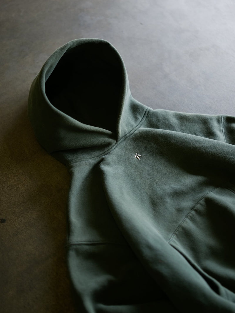 Goji Longevity forest green oversized cropped hoodie — side profile