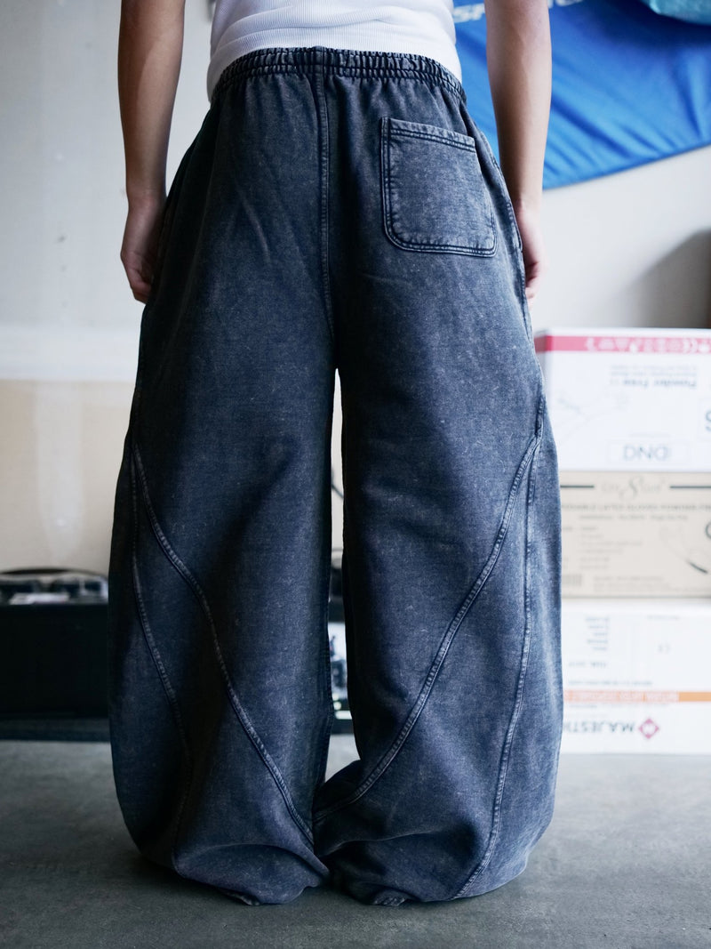 Back view of Goji Longevity acid-washed black wide-fit sweatpants