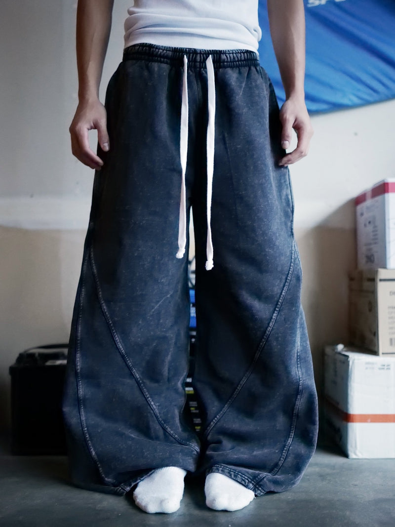Model wearing Goji Longevity black washed wide-fit sweatpants — front