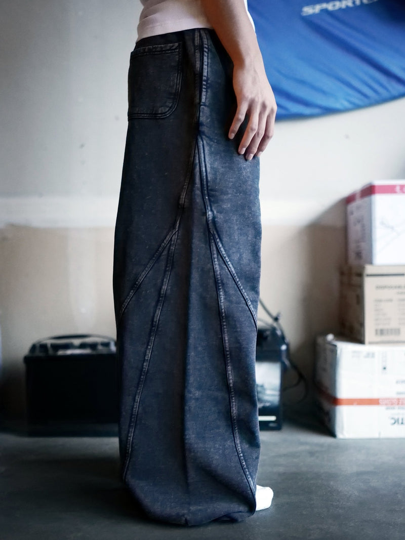 Side view of Goji Longevity acid-washed black wide-fit sweatpants